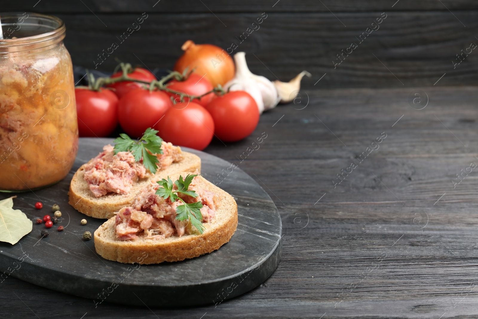 Photo of Sandwiches with canned meat served on wooden table, space for text