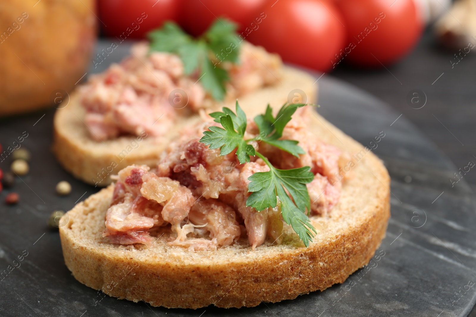 Photo of Sandwiches with canned meat and parsley on table, closeup