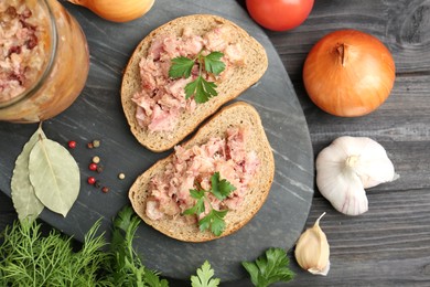 Photo of Sandwiches with canned meat served on wooden table, top view