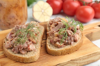 Photo of Sandwiches with canned meat and dill on table, closeup