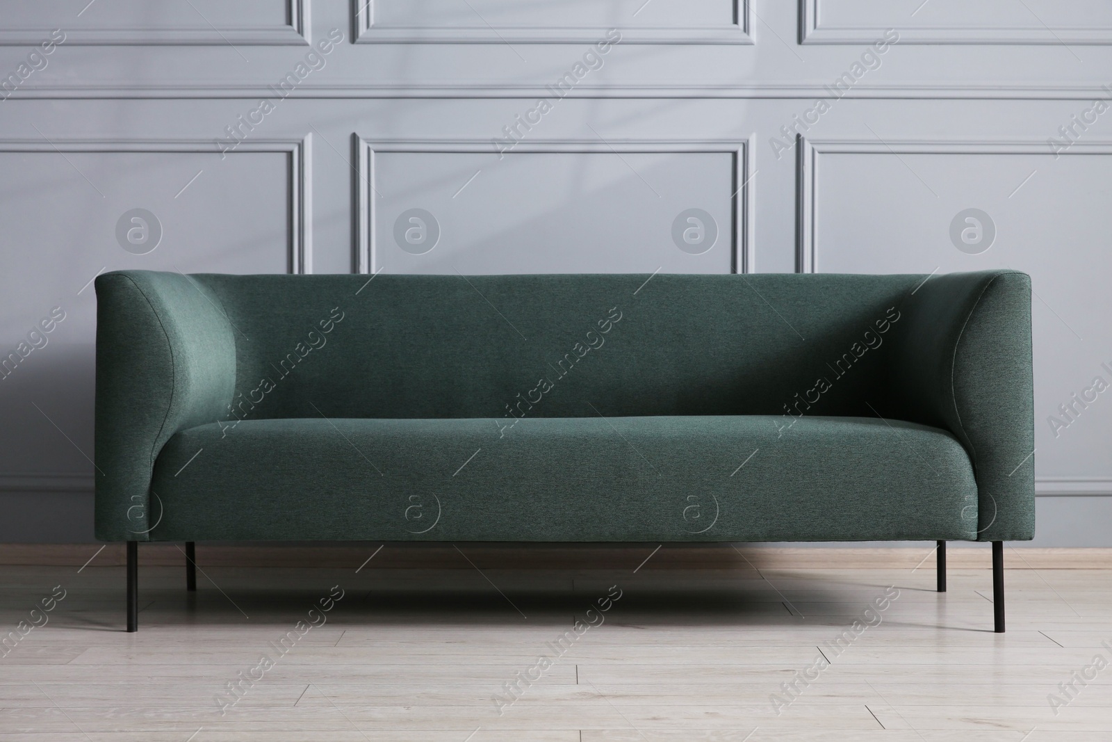 Photo of Comfortable sofa near grey wall in room