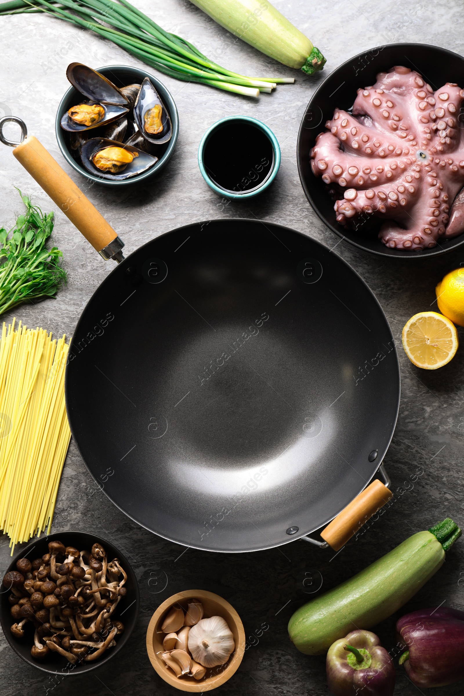 Photo of Ingredients for wok on grey table, flat lay