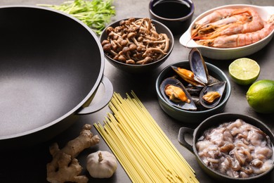 Photo of Ingredients for wok on grey table, closeup