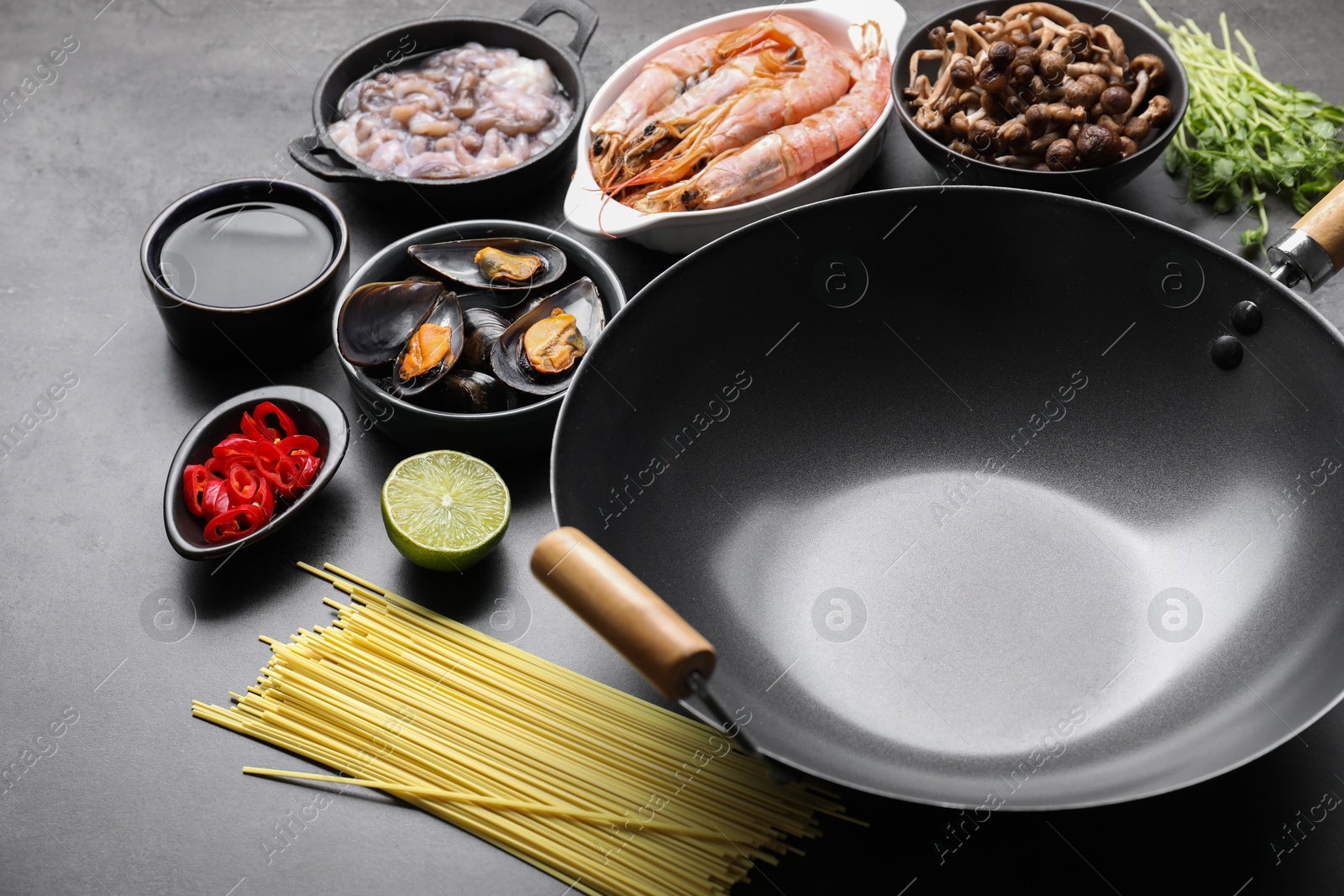 Photo of Ingredients for wok on grey table, closeup