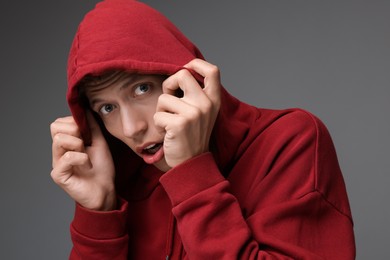 Photo of Portrait of scared young man on gray background