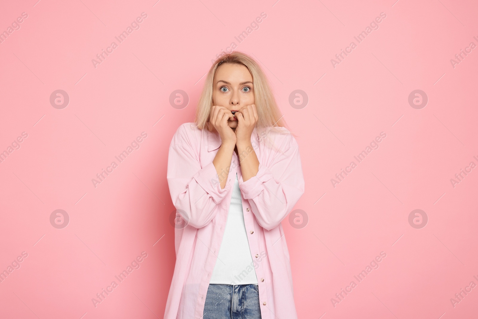 Photo of Portrait of scared woman on pink background