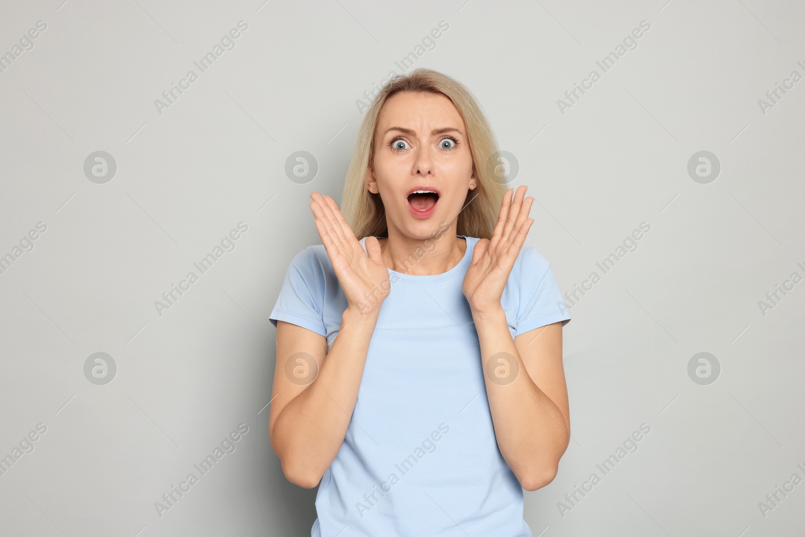 Photo of Portrait of scared woman on gray background