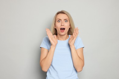 Photo of Portrait of scared woman on gray background