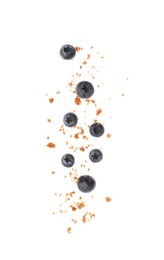 Photo of Fresh blueberries and pieces of crushed muffin isolated on white