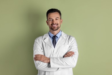 Portrait of smiling doctor on olive background