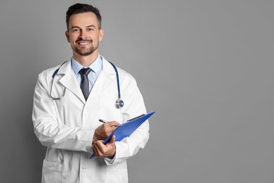 Smiling doctor with stethoscope and clipboard on grey background, space for text