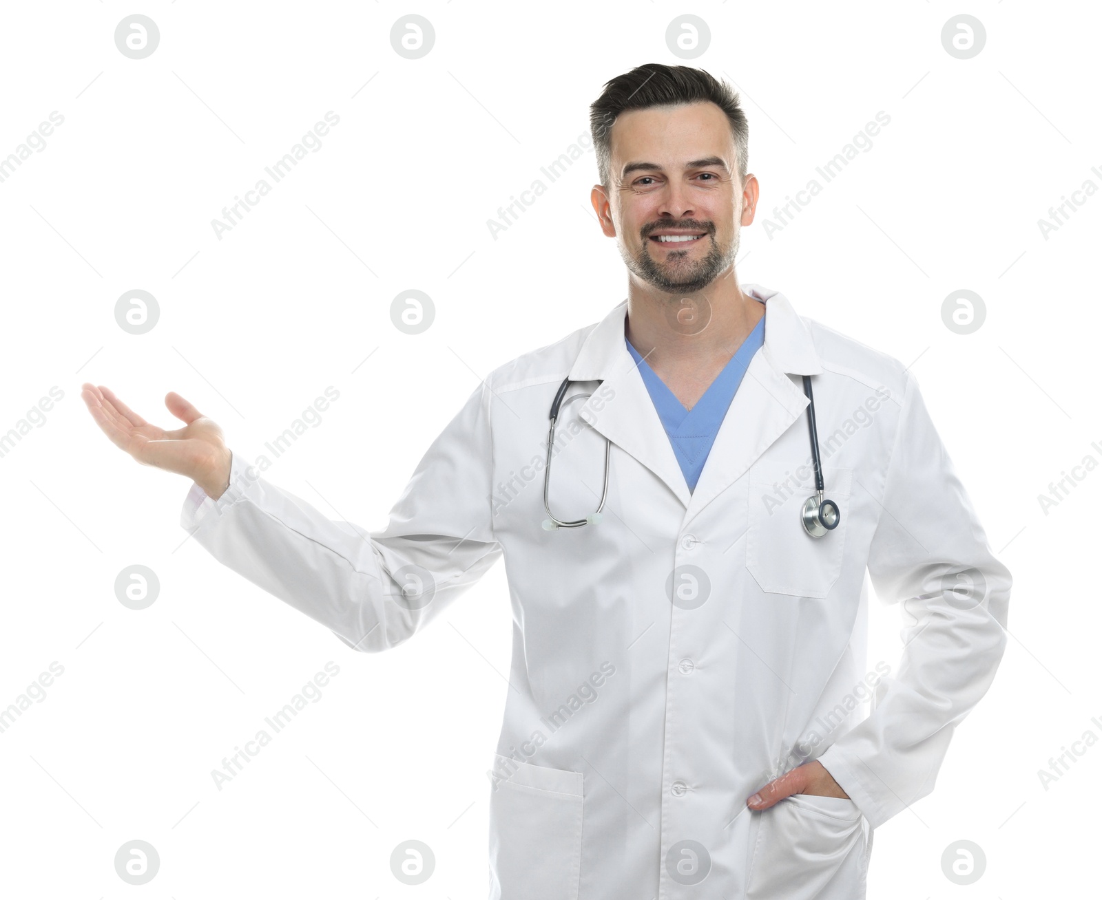 Photo of Smiling doctor with stethoscope pointing at something on white background