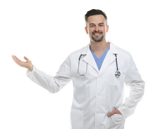 Photo of Smiling doctor with stethoscope pointing at something on white background