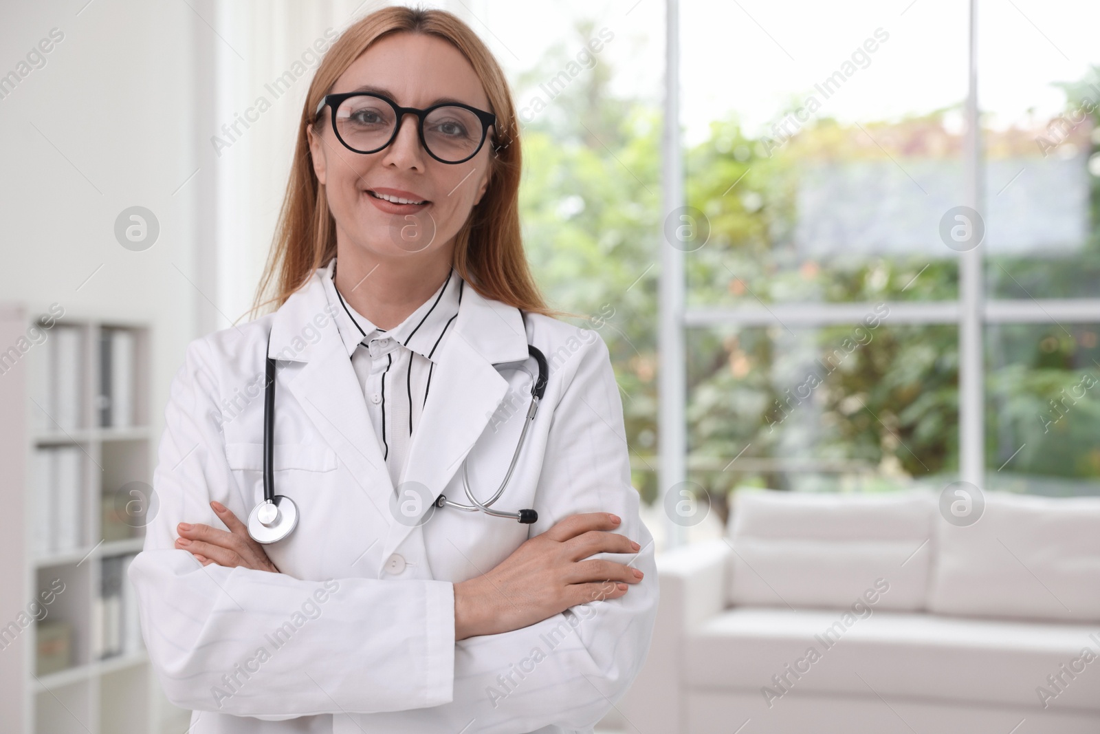 Photo of Portrait of smiling doctor with stethoscope in clinic