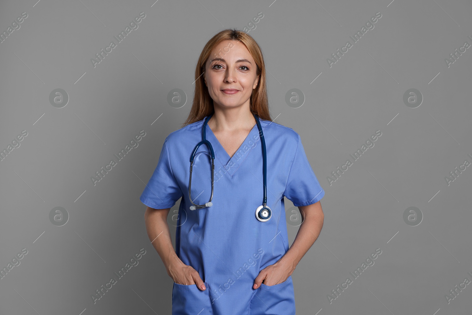 Photo of Portrait of doctor with stethoscope on gray background