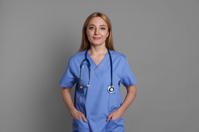 Photo of Portrait of doctor with stethoscope on gray background