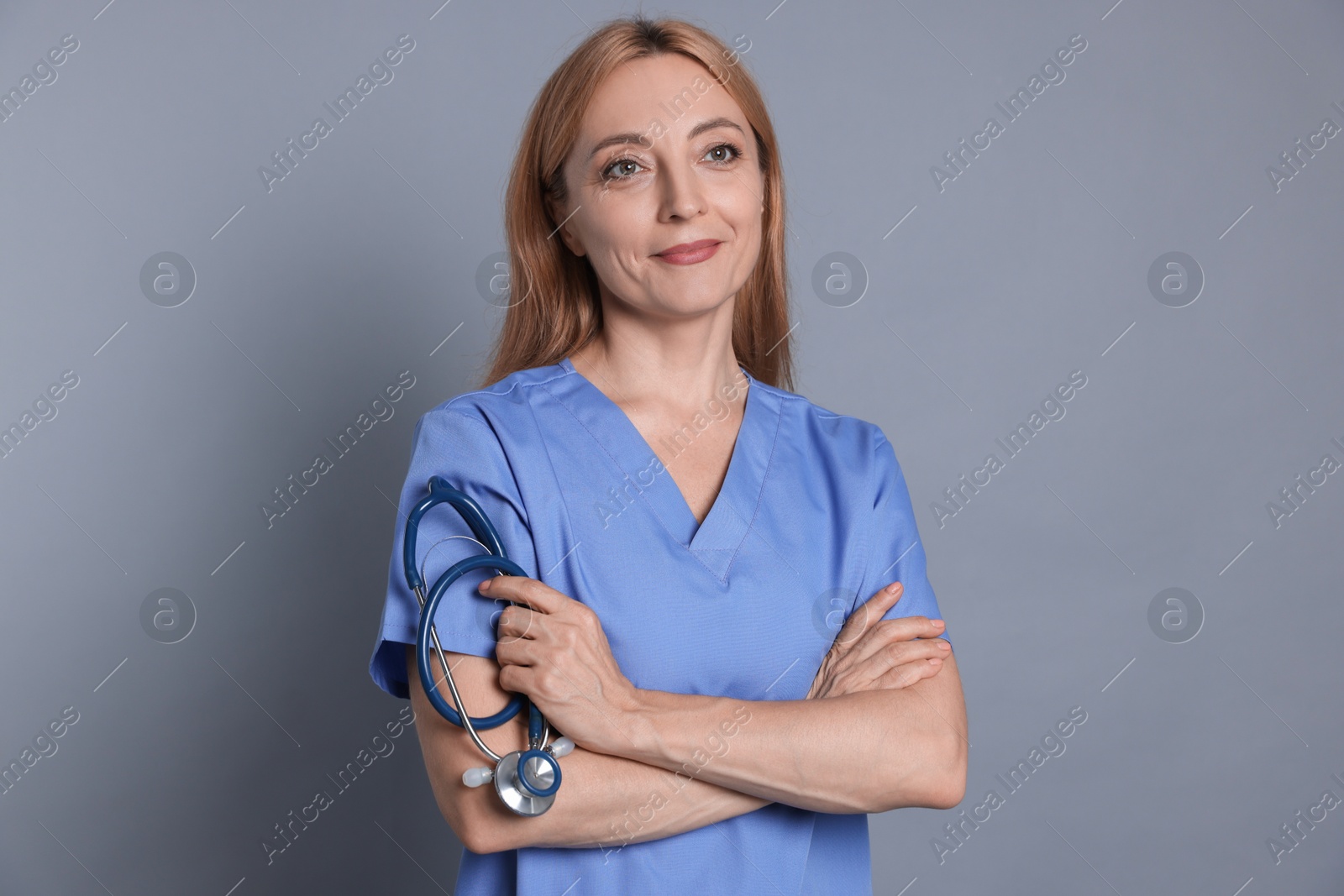 Photo of Portrait of doctor with stethoscope on gray background