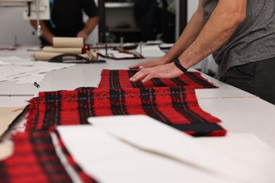 Photo of Man working at white table in professional workshop, closeup