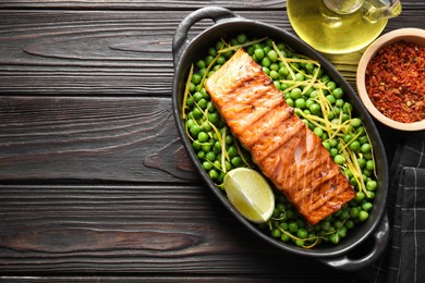 Photo of Delicious grilled salmon fillet in baking dish served on wooden table, flat lay. Space for text