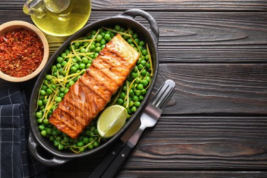 Delicious grilled salmon fillet in baking dish served on wooden table, flat lay. Space for text