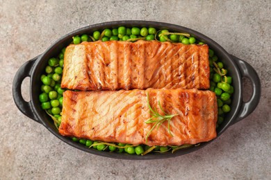 Photo of Delicious grilled salmon fillets with rosemary and green peas in baking dish on grey textured table, top view