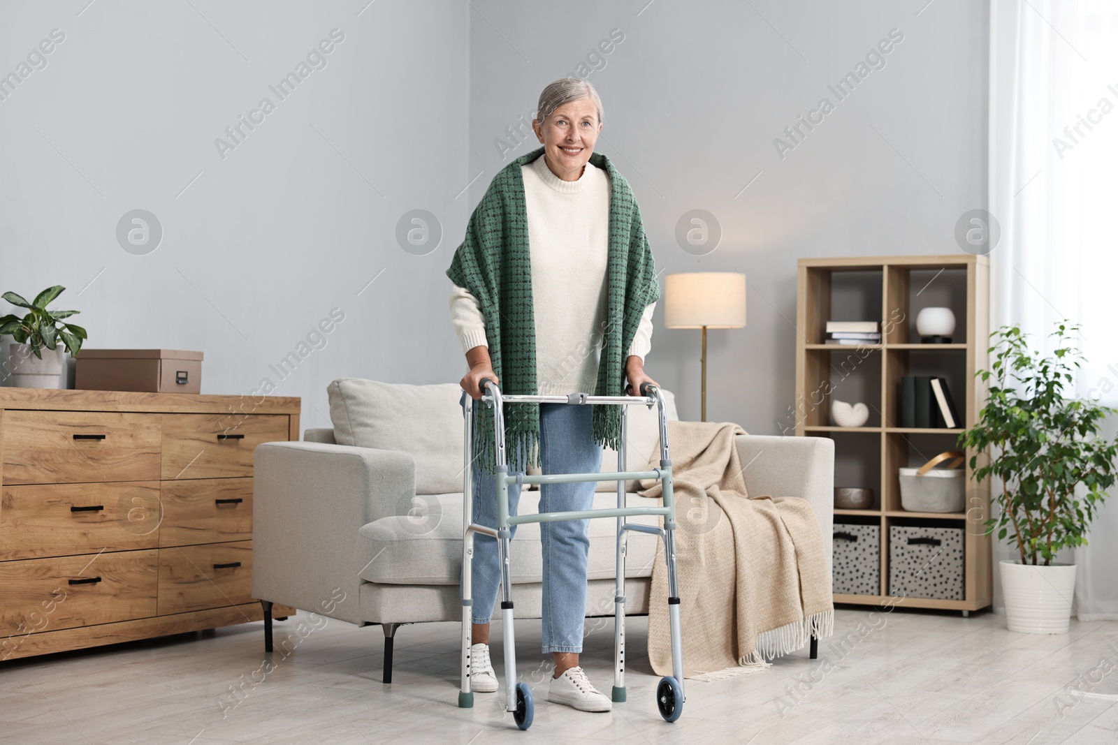 Photo of Senior woman with walking frame at home