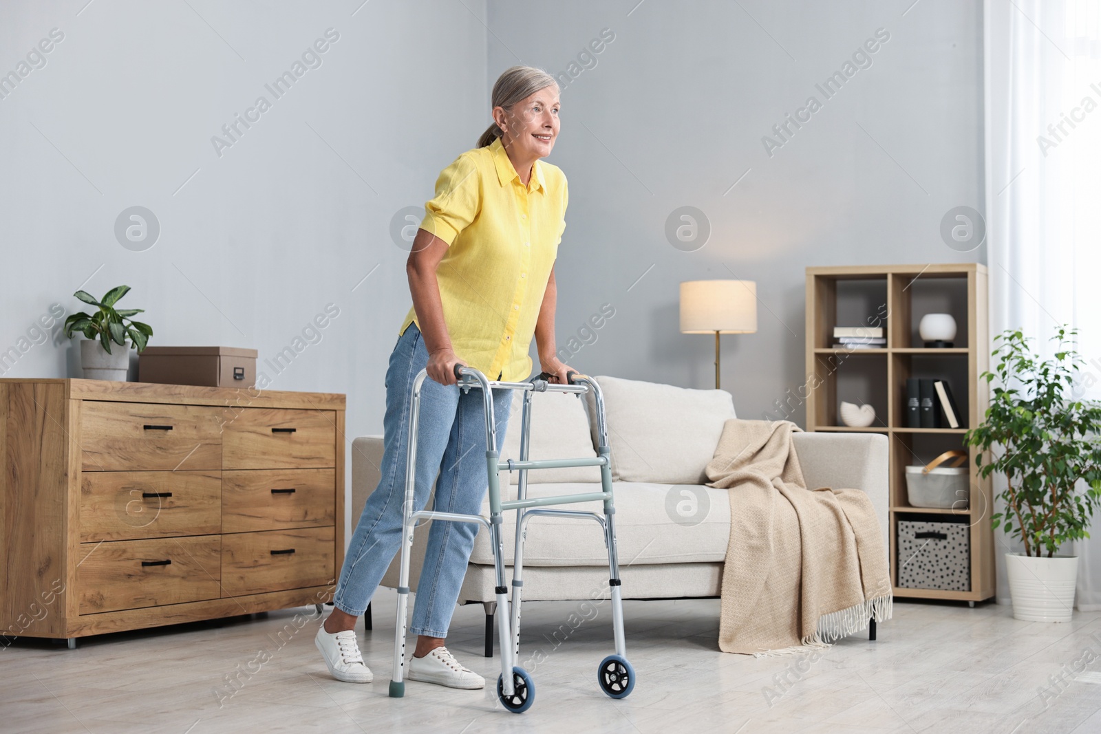 Photo of Senior woman with walking frame at home