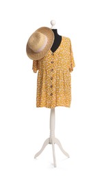 Female mannequin with stylish yellow dress and straw hat isolated on white