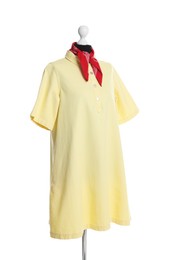 Female mannequin with stylish yellow dress and red handkerchief isolated on white