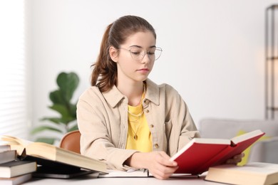 Photo of Student preparing for exam at table indoors