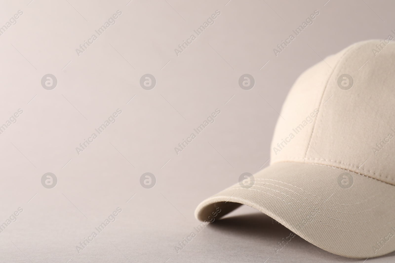 Photo of Stylish baseball cap on light grey background, closeup. Mockup for design