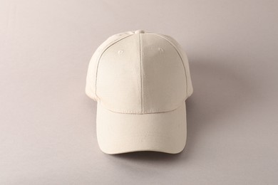 Photo of Stylish baseball cap on light grey background. Mockup for design