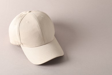 Photo of Stylish baseball cap on light grey background. Mockup for design