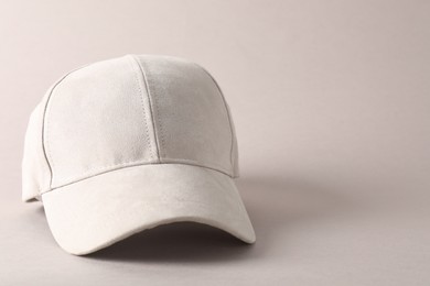 Photo of Stylish baseball cap on light grey background, closeup. Mockup for design