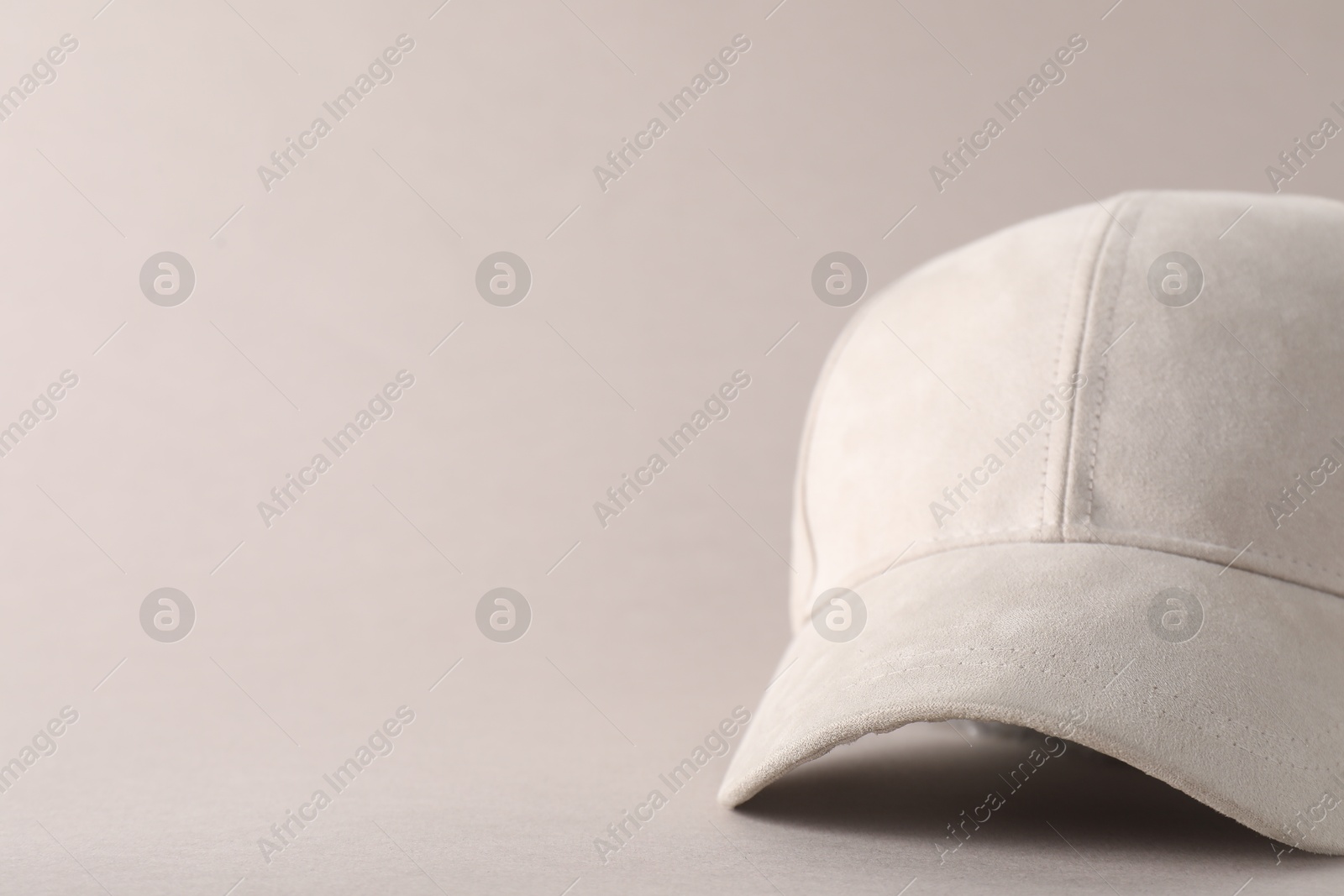 Photo of Stylish baseball cap on light grey background, closeup. Mockup for design