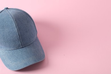 Photo of Stylish denim baseball cap on pink background. Mockup for design