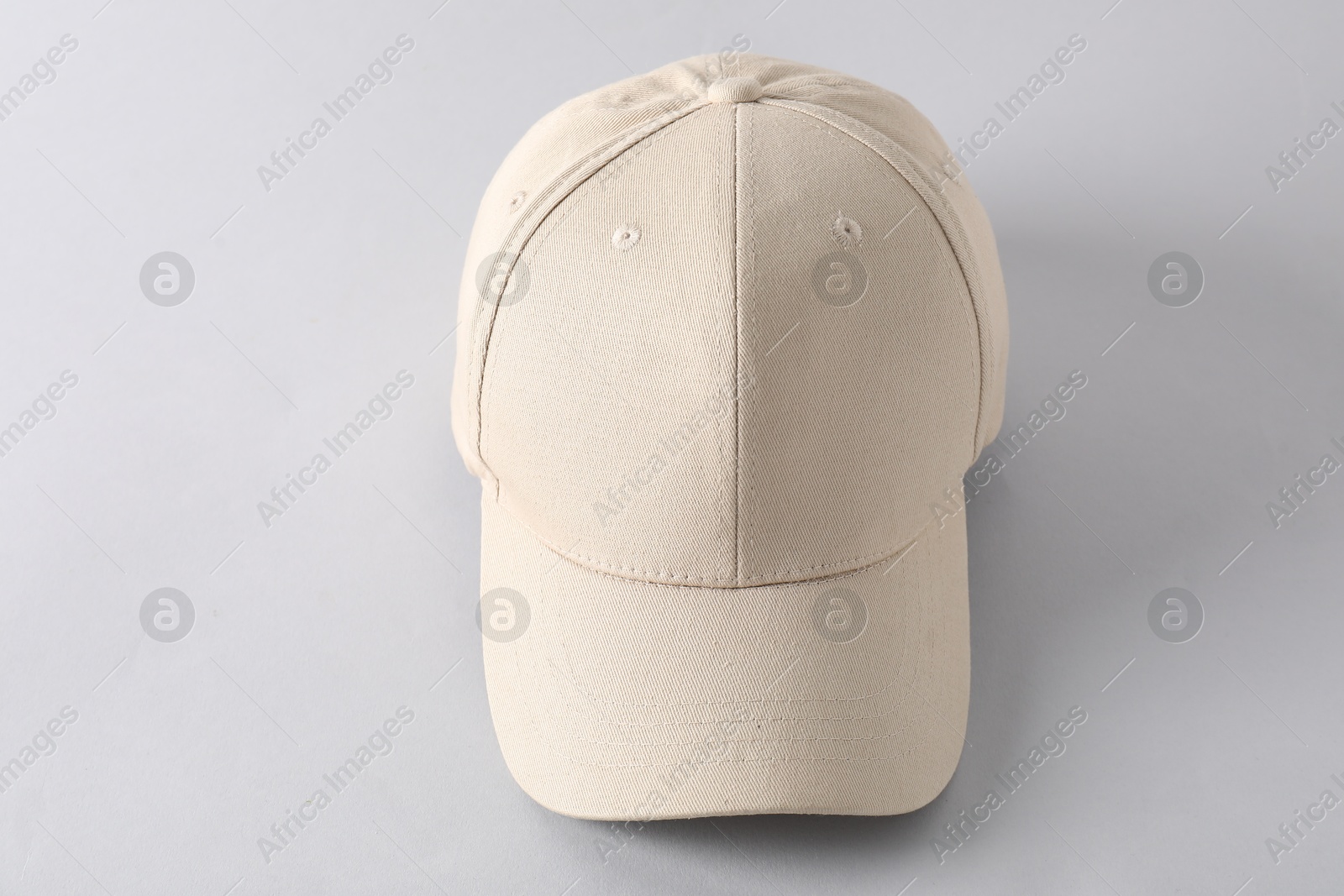 Photo of Stylish baseball cap on light grey background. Mockup for design