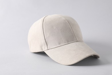 Photo of Stylish baseball cap on light grey background, closeup. Mockup for design