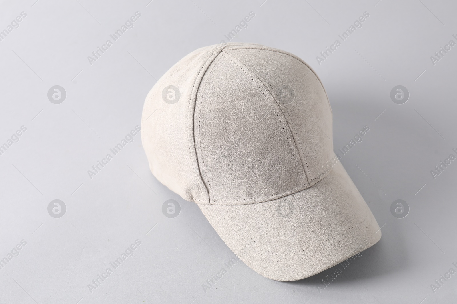 Photo of Stylish baseball cap on light grey background. Mockup for design