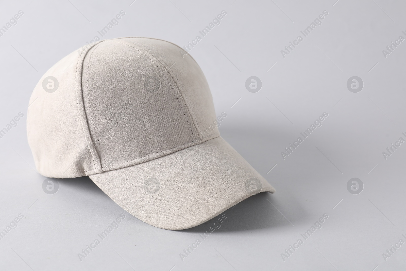 Photo of Stylish baseball cap on light grey background. Mockup for design