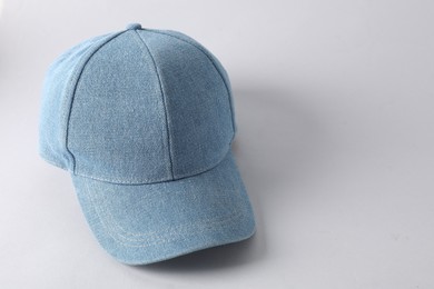 Stylish denim baseball cap on light grey background. Mockup for design