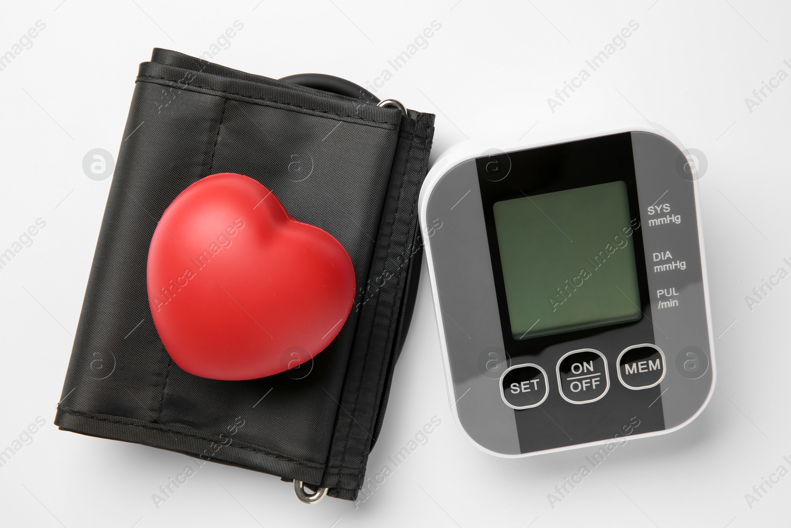 Photo of Blood pressure measuring device and squeeze heart on white background, top view