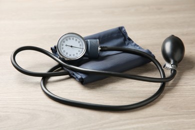 Photo of Blood pressure measuring device on wooden table