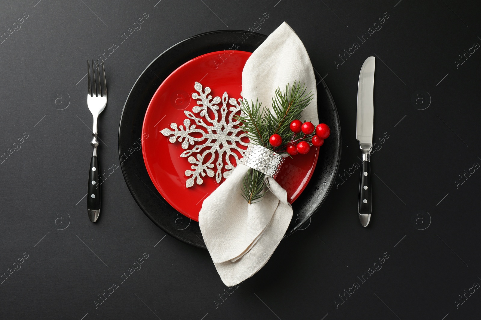 Photo of Christmas setting with festive decor on dark table, flat lay