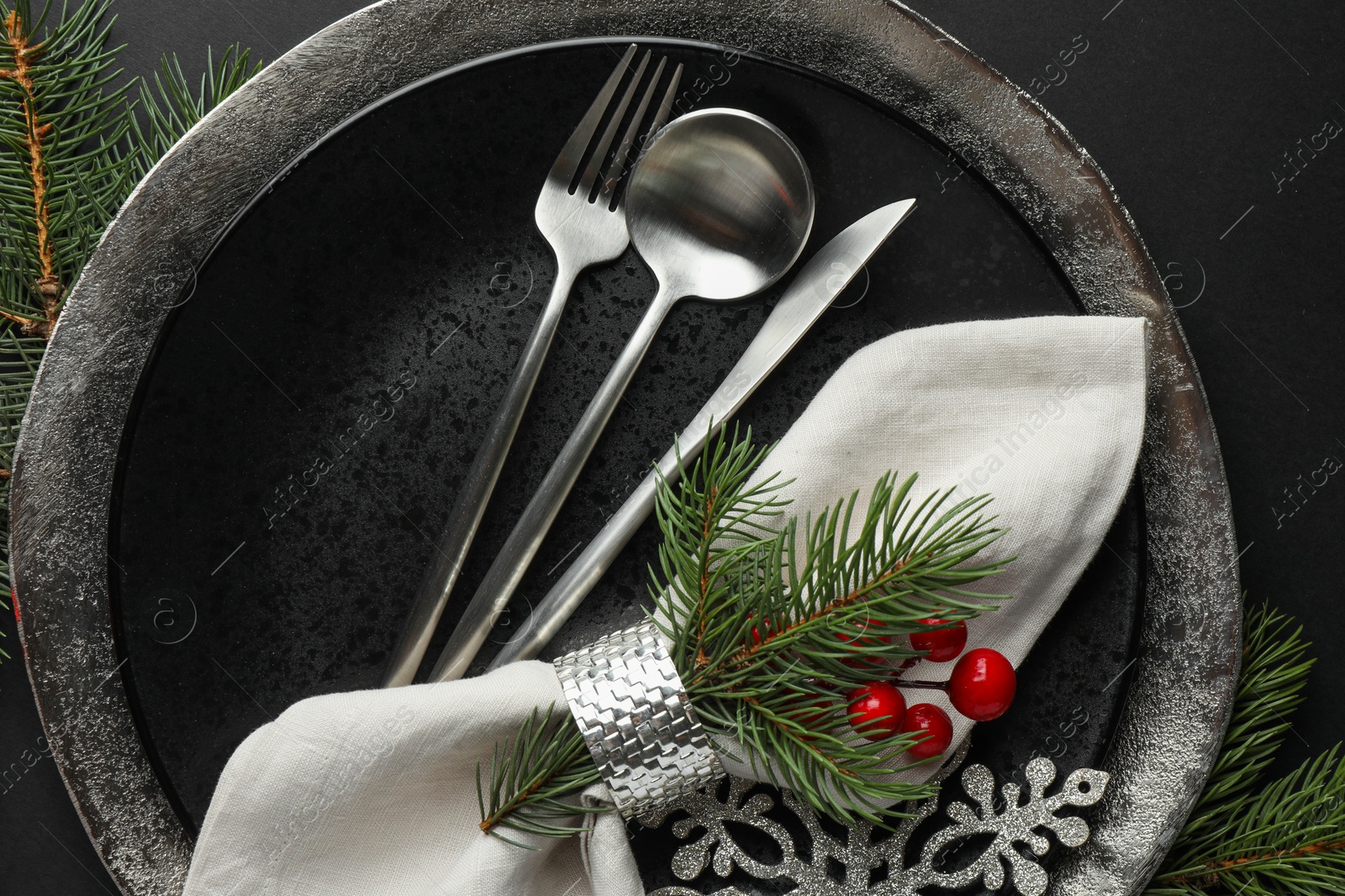 Photo of Christmas setting with festive decor on dark table, flat lay