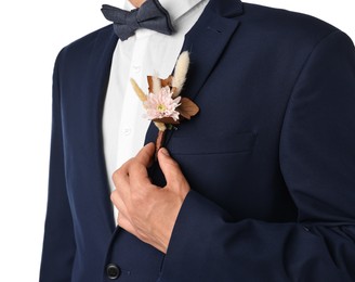 Photo of Groom in suit with stylish boutonniere on white background, closeup