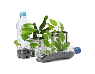 Photo of Recycling concept. Plastic bottles and cans with plants isolated on white