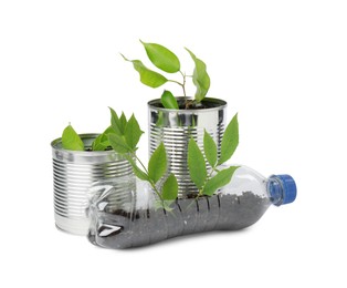 Photo of Recycling concept. Plastic bottle and cans with plants isolated on white