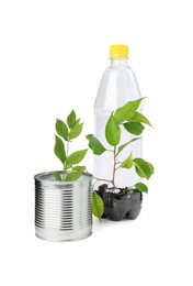 Photo of Recycling concept. Plastic bottle and can with plants isolated on white