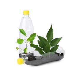 Photo of Recycling concept. Plastic bottles with plants isolated on white